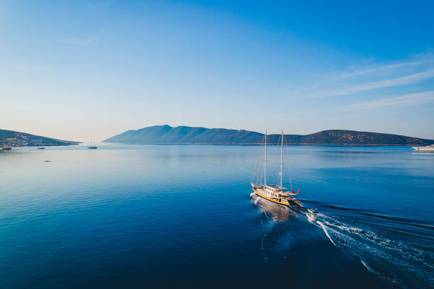A boat sailing on clear blue Mediterranean water